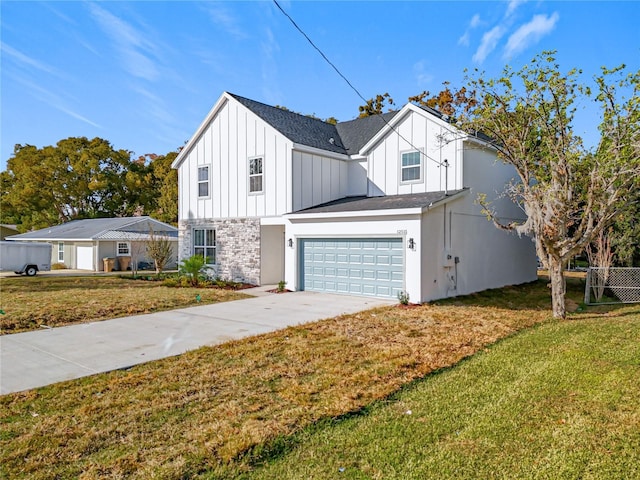 view of front of home with a front yard and a garage