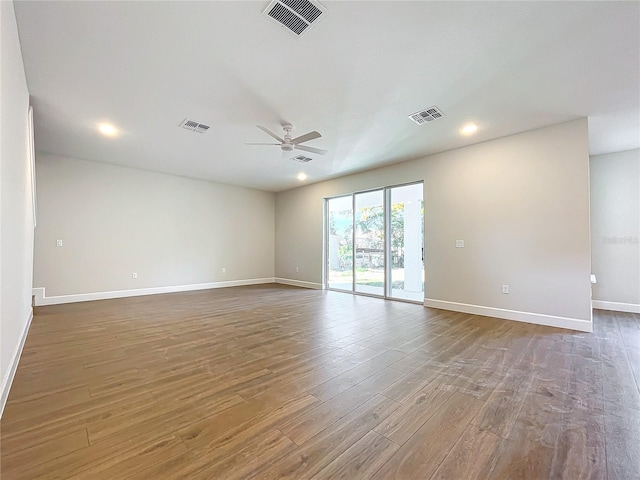 empty room featuring hardwood / wood-style floors and ceiling fan