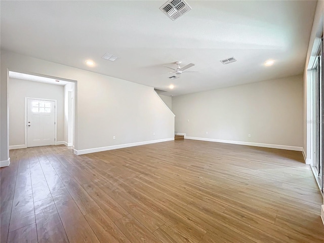 empty room with hardwood / wood-style floors and ceiling fan