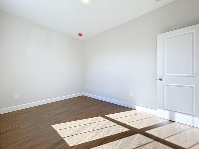 unfurnished room with hardwood / wood-style floors