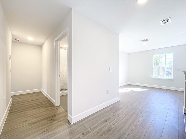 unfurnished room with wood-type flooring