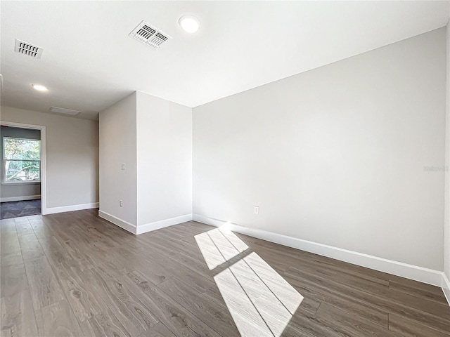 spare room with dark hardwood / wood-style flooring