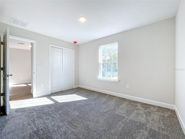 unfurnished bedroom with carpet floors and a closet