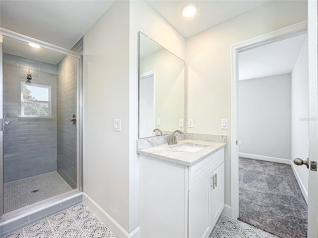 bathroom with a shower with door and vanity