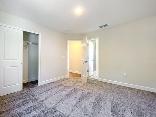 unfurnished bedroom with carpet and a closet