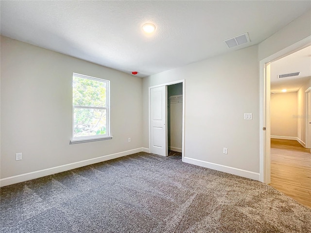 unfurnished bedroom featuring a closet and carpet