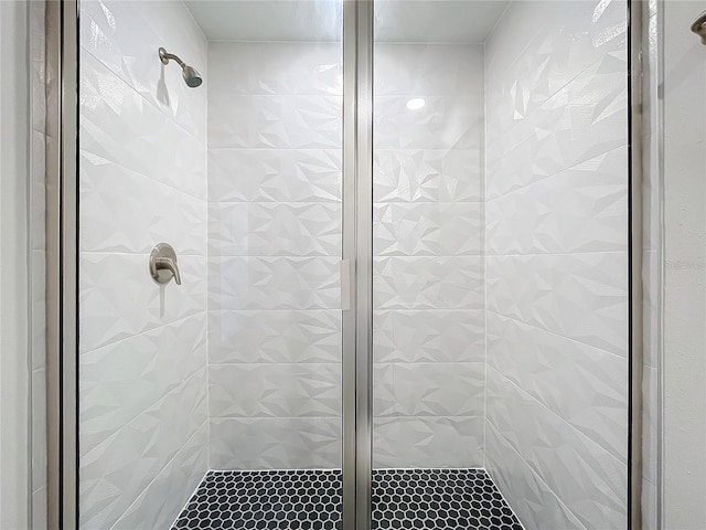 bathroom featuring a shower with door