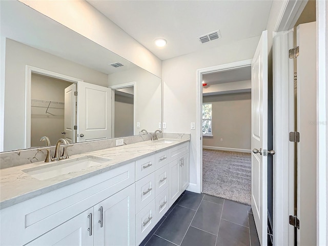 bathroom with tile patterned flooring and vanity