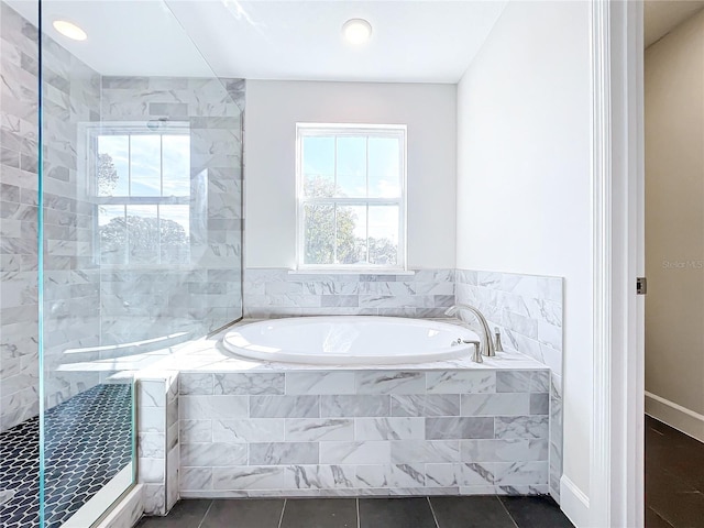 bathroom featuring tile patterned flooring and independent shower and bath