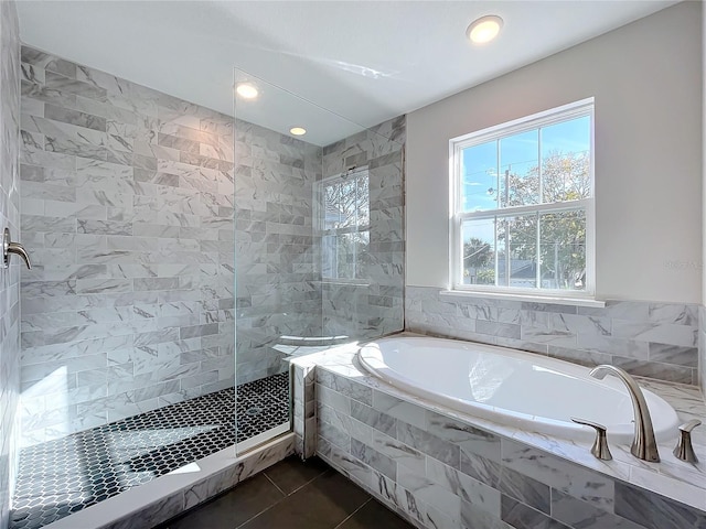 bathroom featuring tile patterned flooring, tile walls, and plus walk in shower