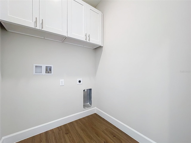 clothes washing area with hookup for an electric dryer, cabinets, dark wood-type flooring, and hookup for a washing machine