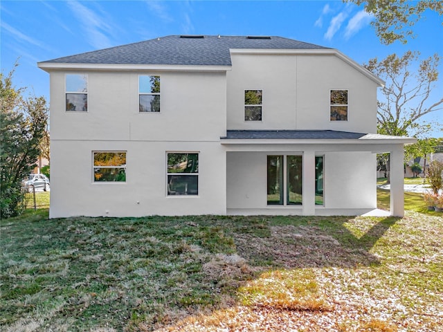 back of property featuring a lawn and a patio