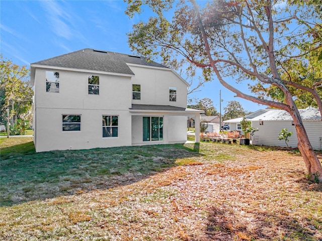 rear view of property with a yard