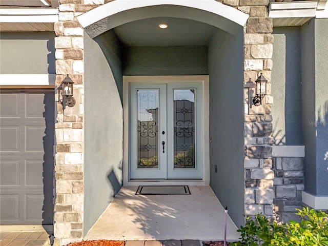 4408 Renly Ln, Clermont, FL 34711 - entrance to property featuring stone siding, french doors, and stucco siding