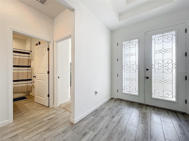 4408 Renly Ln, Clermont, FL 34711 - entryway with light wood finished floors, french doors, and a tray ceiling