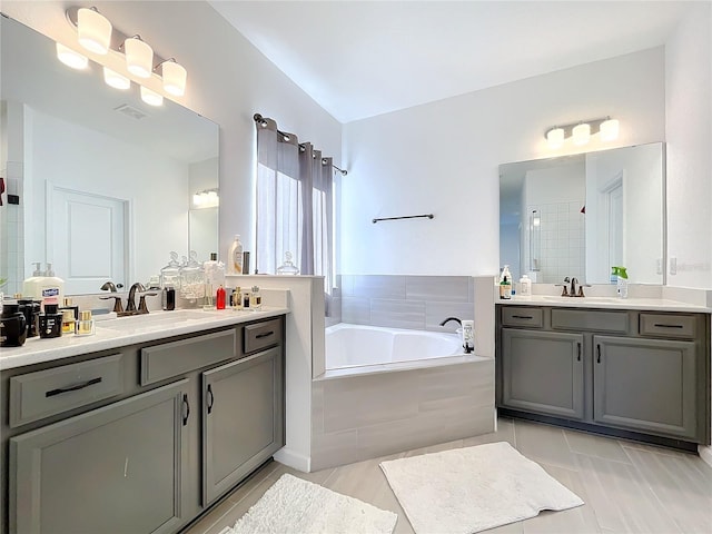 4408 Renly Ln, Clermont, FL 34711 - bathroom featuring two vanities, a bath, a tile shower, and tile patterned flooring