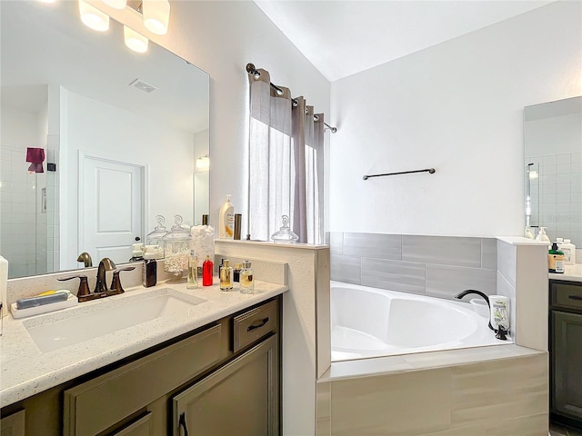 bathroom featuring vanity and separate shower and tub