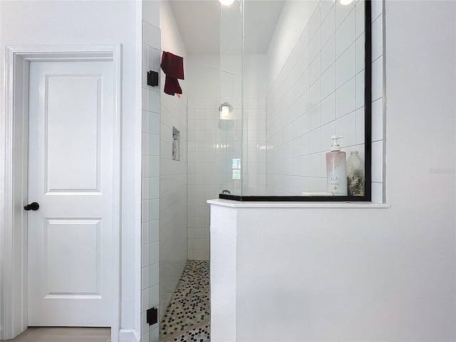 bathroom with a tile shower