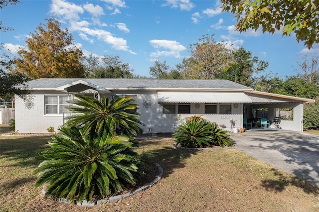 ranch-style home with a front yard and a carport