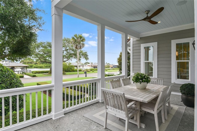 sunroom with a water view, wood ceiling, and ceiling fan