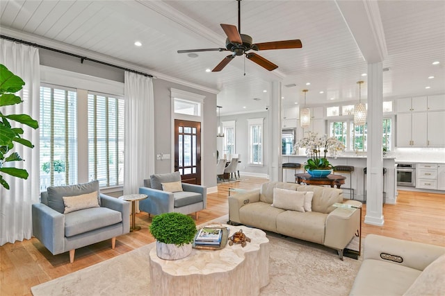 living room with ceiling fan, crown molding, wood ceiling, and light wood-type flooring