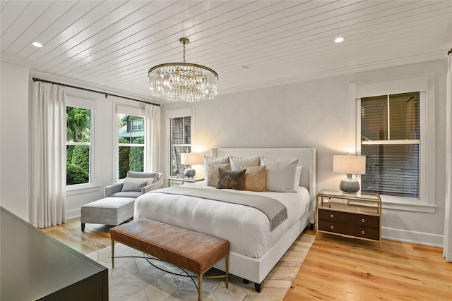 bedroom with a notable chandelier, wood ceiling, ornamental molding, and light hardwood / wood-style flooring