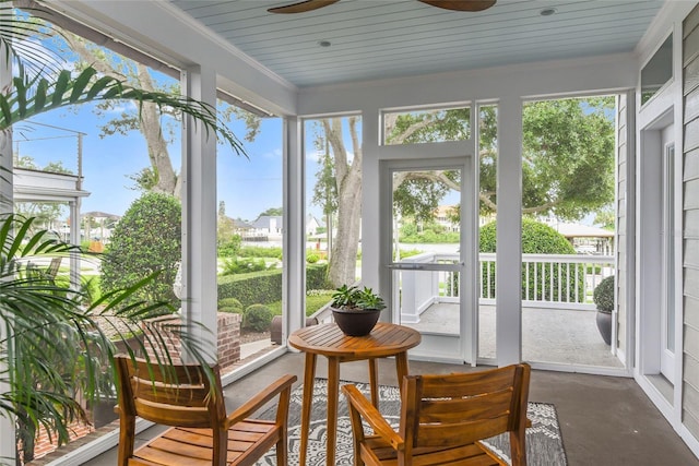 sunroom / solarium featuring ceiling fan