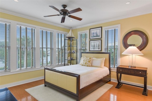 bedroom featuring ornamental molding, baseboards, and wood finished floors