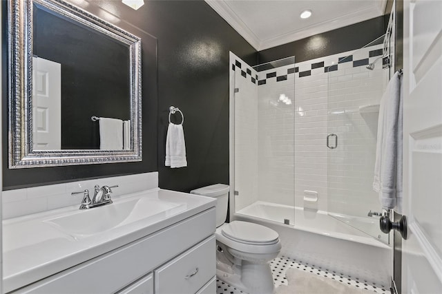 full bathroom featuring vanity, tiled shower / bath, tile patterned flooring, toilet, and ornamental molding