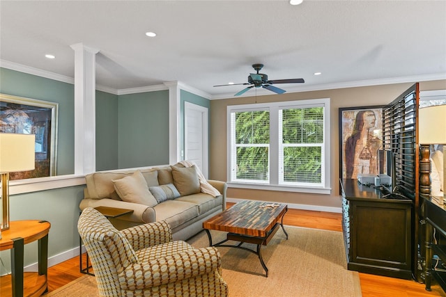 living room with ceiling fan, light hardwood / wood-style flooring, and ornamental molding