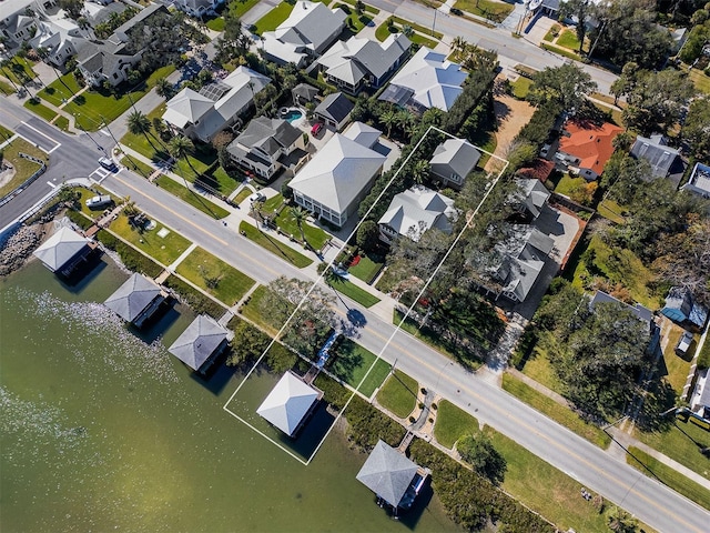 drone / aerial view with a water view and a residential view