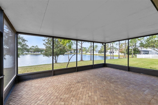 unfurnished sunroom with a water view