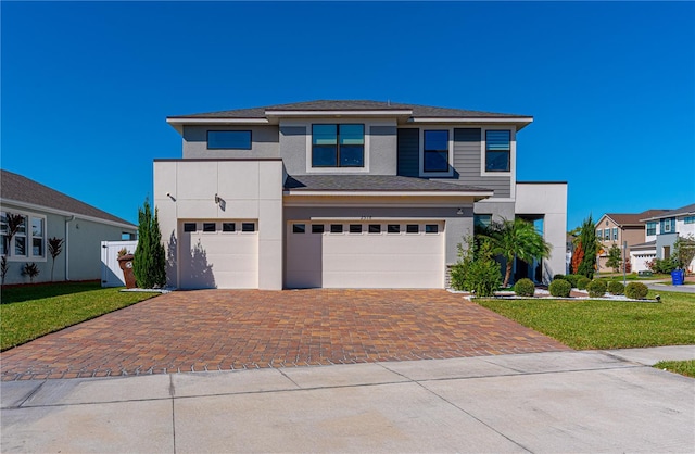 view of front facade with a garage and a front yard