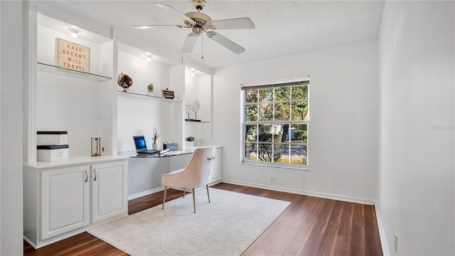 office space featuring a textured ceiling, ceiling fan, and dark hardwood / wood-style flooring