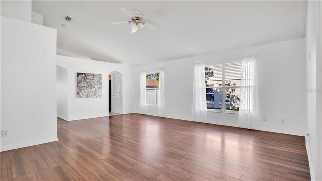 spare room featuring ceiling fan, dark wood-type flooring, and vaulted ceiling