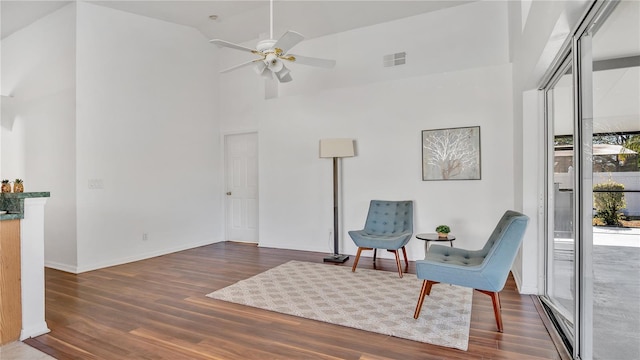 sitting room featuring vaulted ceiling, ceiling fan, and dark hardwood / wood-style floors