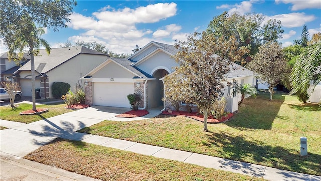 view of front of property featuring a front lawn and a garage