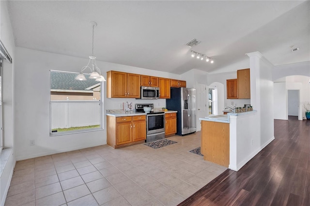 kitchen featuring sink, hanging light fixtures, light tile patterned floors, and stainless steel appliances