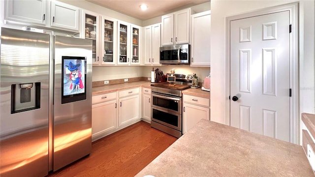 kitchen with white cabinetry, light hardwood / wood-style flooring, and appliances with stainless steel finishes