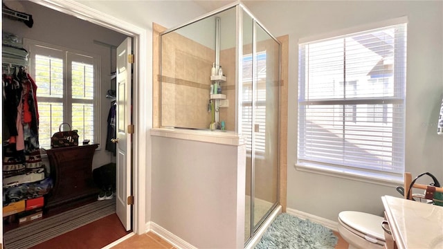 bathroom featuring vanity, an enclosed shower, and toilet