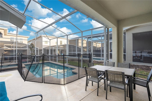 view of swimming pool with a hot tub, a lanai, and a patio area