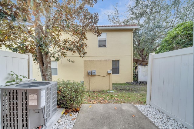 back of house featuring central AC