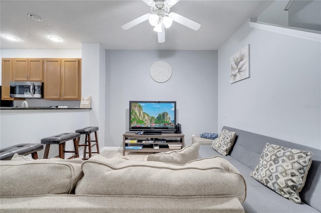 living room featuring carpet flooring and ceiling fan