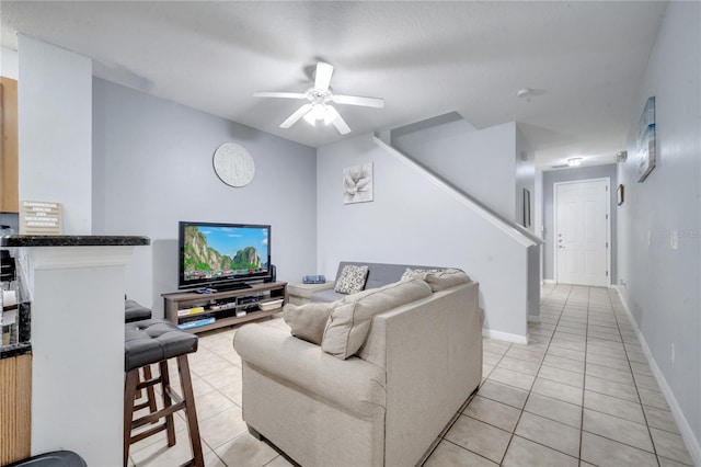 living room with light tile patterned floors and ceiling fan