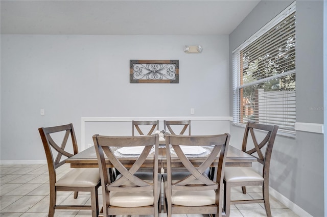 dining space featuring light tile patterned floors