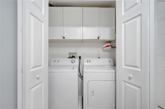 laundry area featuring washer and dryer and cabinets