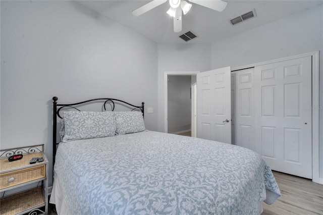 bedroom featuring a closet, light hardwood / wood-style flooring, and ceiling fan