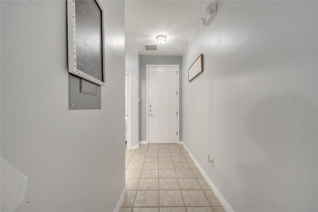 corridor featuring light tile patterned floors