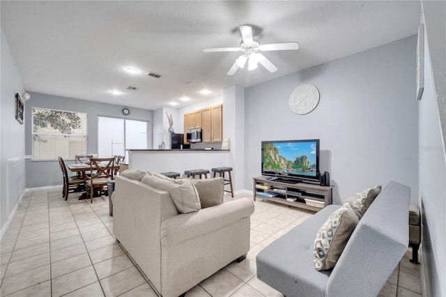 living room with ceiling fan and light tile patterned floors