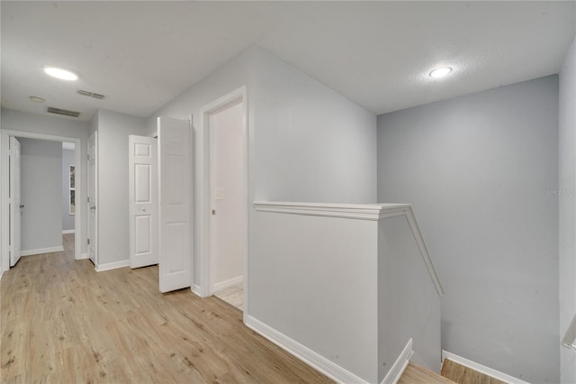 hall with light hardwood / wood-style flooring